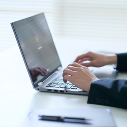 Two hand on an open laptop typing