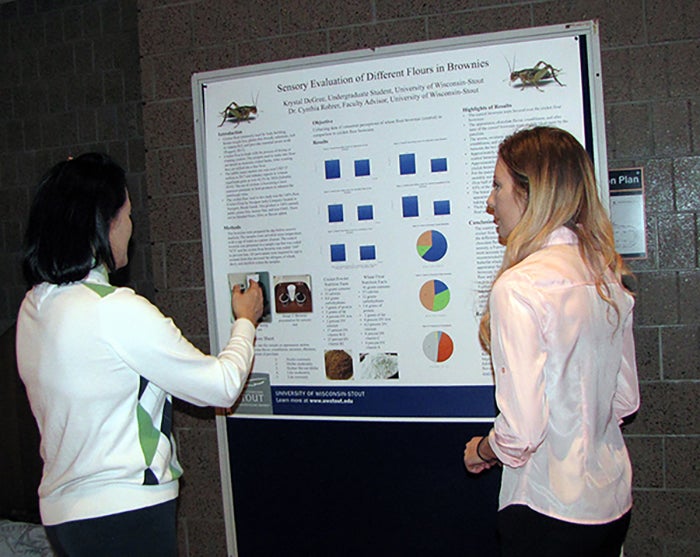 Krystal Degree, right, and Eun Joo Lee, food and nutrition department chair, discuss DeGree’s research on flour made from crickets.