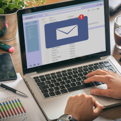 An open laptop with a big email icon in display