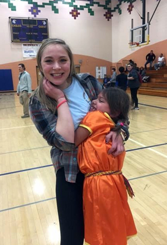 UW-Stout student Katrina Thompson gets a hug from an LCO student.
