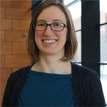 Young woman with glasses and brown shoulder length hair