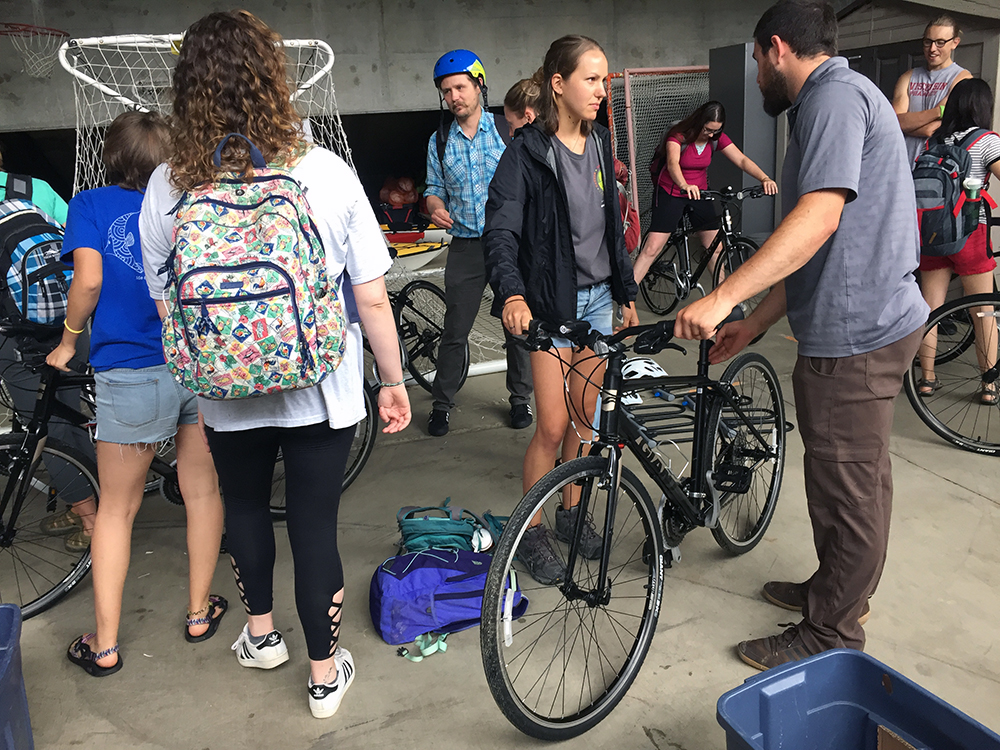 Houston Taylor, Stout Adventures, at right, explains the fit of a bike to LAKES REU student Kirsten Ondris, of Vernon, N.J. 