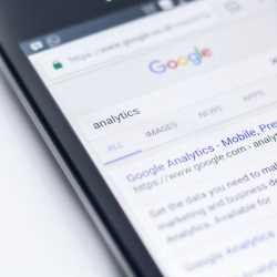 A phone display showing a google search on analytics