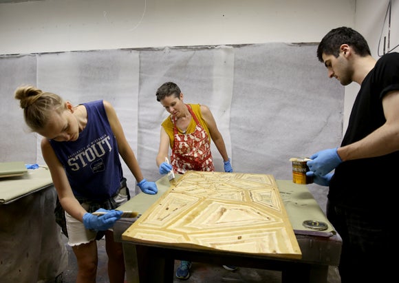 UW-Stout’s Jennifer Astwood, center, and Russian designers Yaroslava Barmenkova, left, and Azamat Tavitov work on sensory safety devices during a two-week program at UW-Stout.  