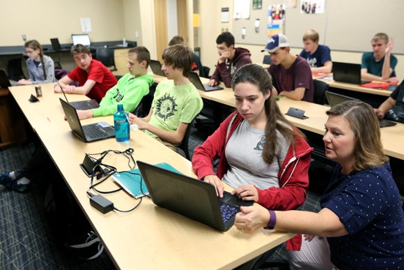Professor Diane Christie, right, helps students in a Computer Science I class in September at UW-Stout, which has been named a national Center of Academic Excellence in Cyber Defense.