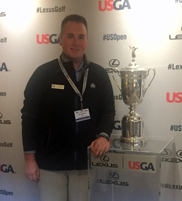 Ryan Hoag, a golf operations intern from UW-Stout, checks out the U.S. Open trophy at Erin Hills.