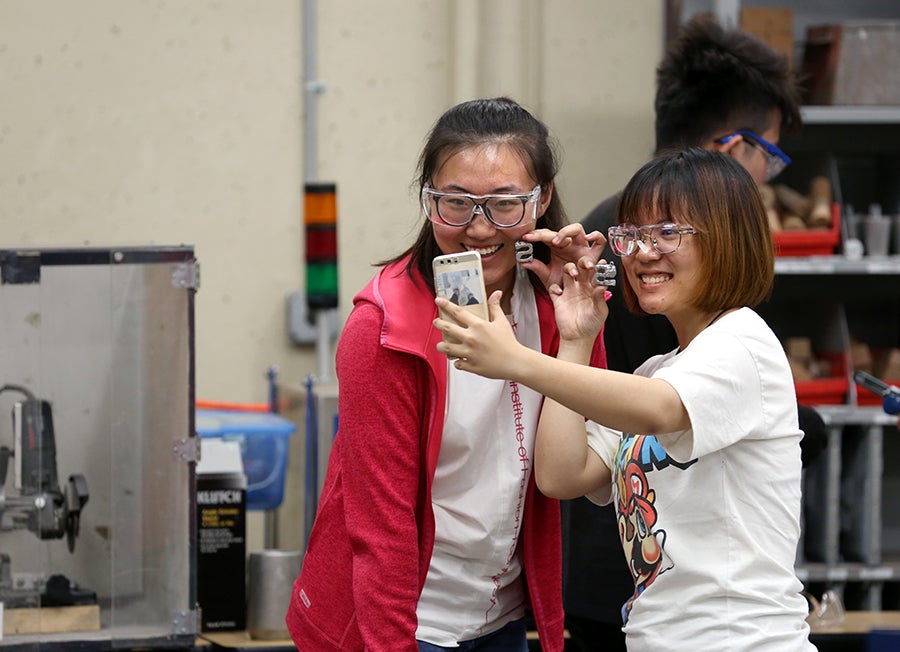 Beijing students visiting UW-Stout marvel at the “S” logo keychains cast at the campus foundry.