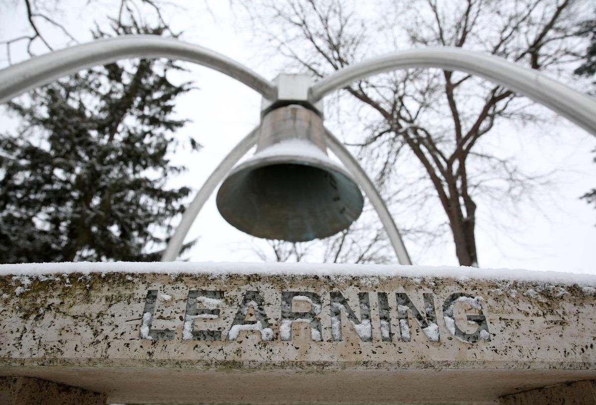Image of a bell hanging above a sign that reads Learning 