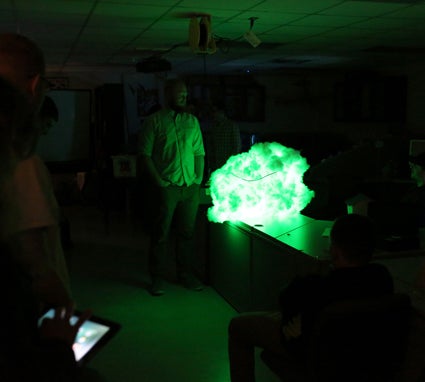 Student William Hibbard explains his project, a “cloud” wired and programmed to change colors.