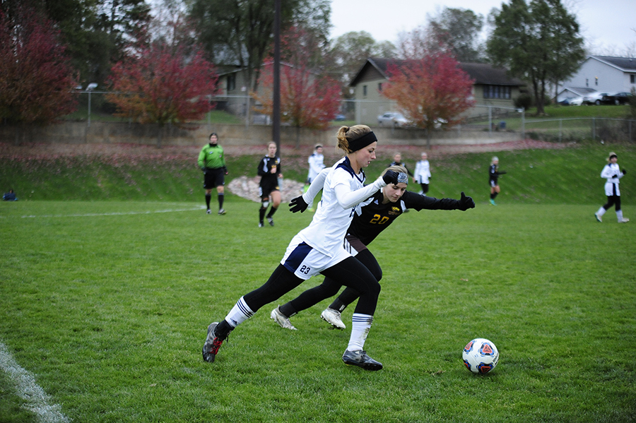 A UW-Stout soccer player, in white, works against an opponent during a 2017 game at Nelson Field. The field is being updated this fall, including the installation of artificial turf.