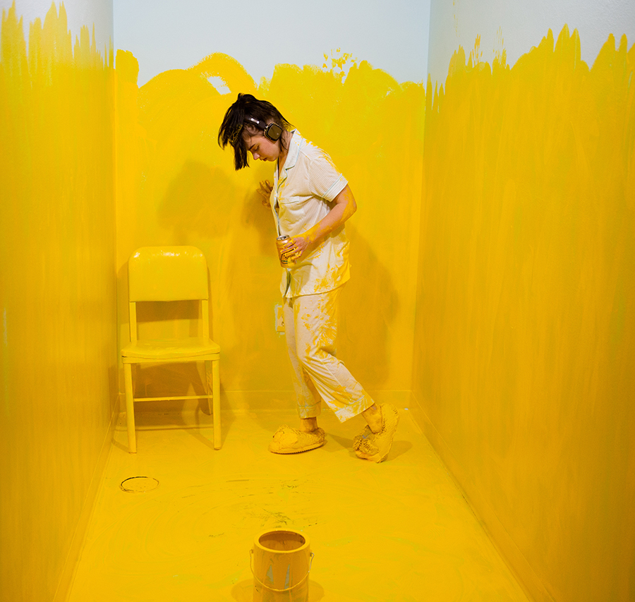 UW-Stout studio art major Gemma Schlotthauer paints during the School of Art and Design Senior Show on May 3.