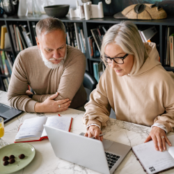 A Man and a Woman Using Laptops