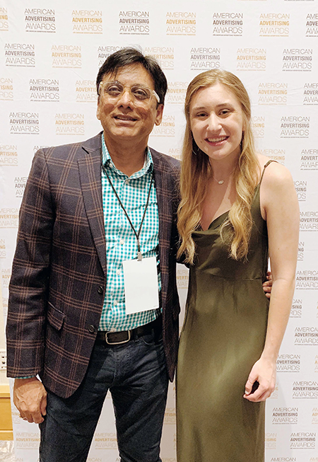 Kelsey Willaby celebrates with Professor Nagesh Shinde after receiving a silver Addy award in the student division of the American Advertising Awards in Hollywood, Fla.