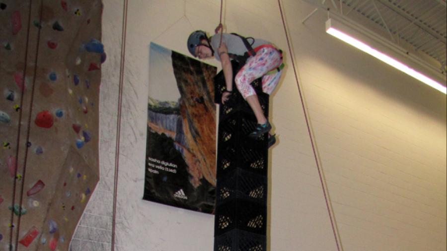 Corrine Prince balances on 17 crates she stacked during a competition at UW-Stout. Prince says the stacking requires balance and concentration.
