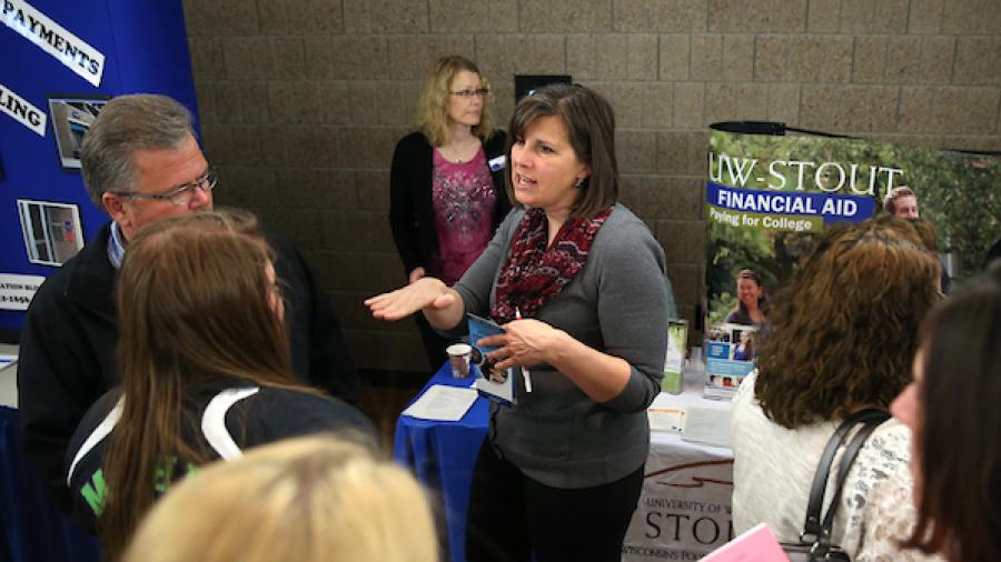A group of people talk about financial aid at a college resource fair