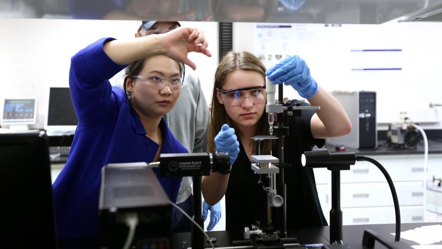 Associate Professor Min DeGruson works with students in the packaging lab.