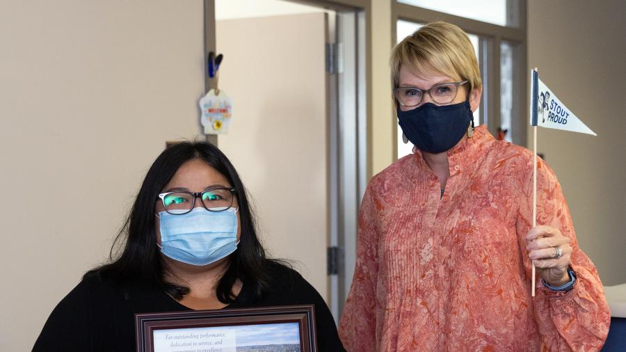 Lor, at left, receiving the University Staff Appreciation Award from Chancellor Katherine Frank.