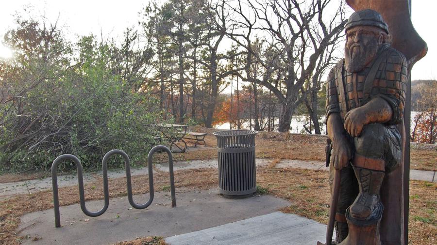 Brush waiting to be hauled away near the lumberjack statue.