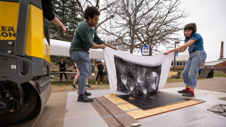 Revealing a print after being pressed.