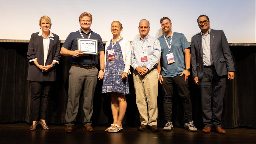 Chancellor Katherine Frank, left, and Josh Bernin, second from left, gather on the stage with event officials after the Quick Pitch finals. Frank was the event moderator. / UW-La Crosse photo