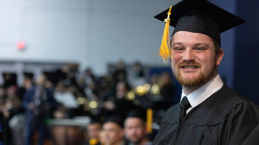 Devin Dumke celebrates at commencement on Dec. 17.