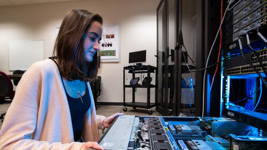 UW-Stout student Christina Kimball checks on equipment in a UW-Stout cybersecurity lab.