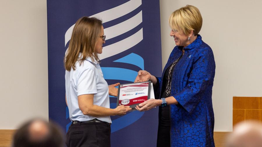 Chancellor Katherine Frank presents the award to 3M Site Director Janice Neitzel.