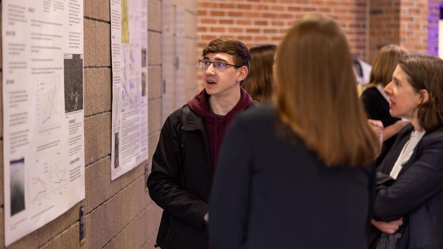 A student speaks with guests during the Polytechnic Showcase following the first day of Board of Regents meetings.