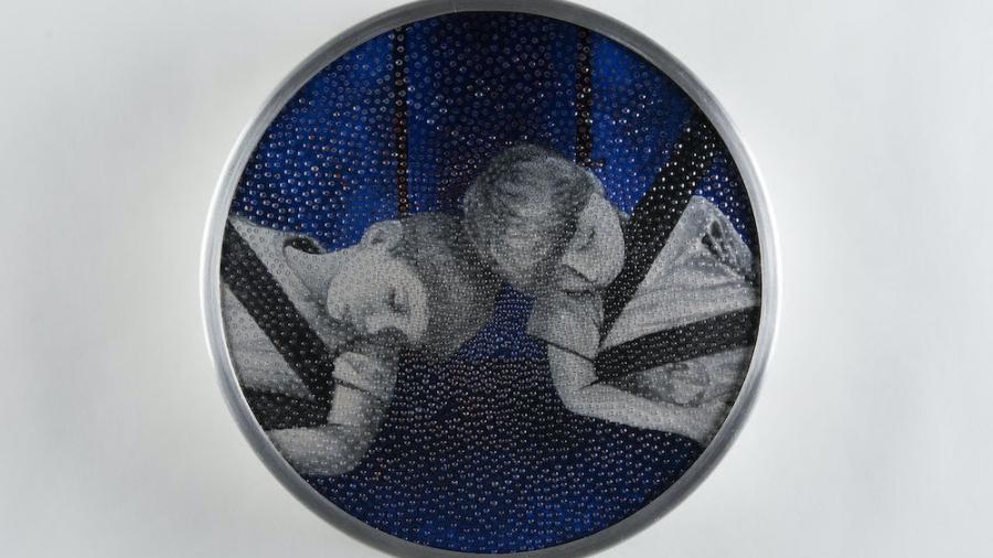 young Metal piece depicting two boys asleep with their heads together in the backseat of car