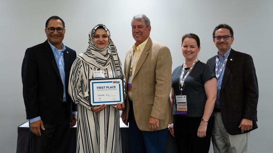 Areeba Ali being presented her first place award