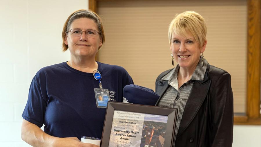 Nicole Baker, left, receives the October University Staff Employee Appreciation award from Chancellor Katherine Frank.