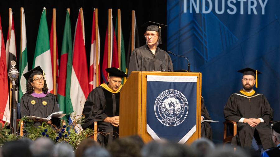 Polly Berendes, who received a master’s degree, addresses fellow Graduate Studies graduates.