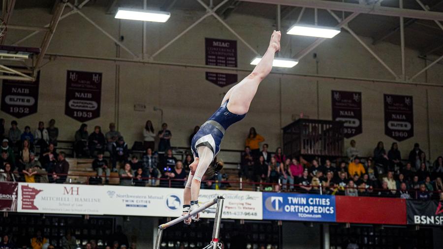 Effie Ferguson competes on the uneven bars at the WIAC/regional meet. She posted a career-best score of 9.7 to help the Blue Devils reach the national meet.