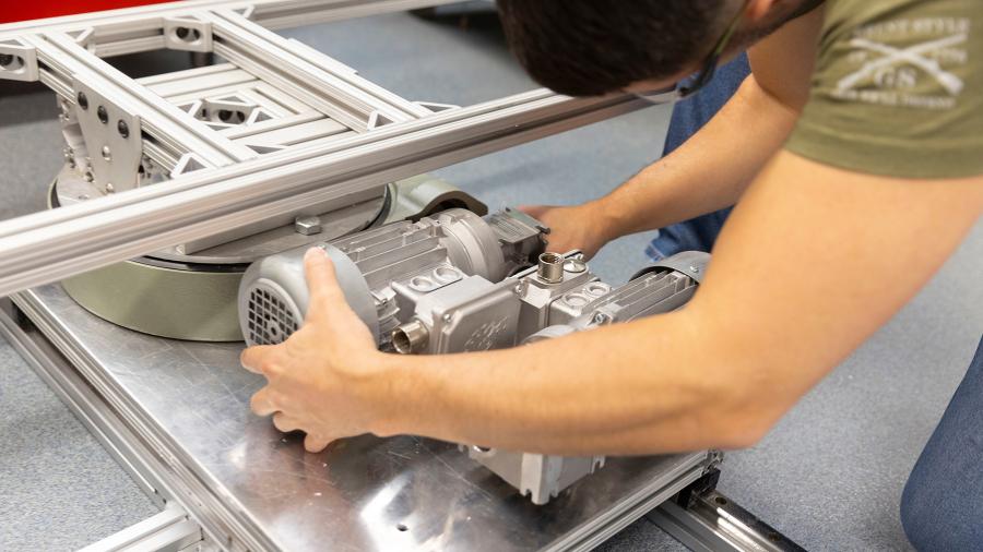 A Senior Design Experience student assembles components as part of a material handling cart improvement project for an industry client.