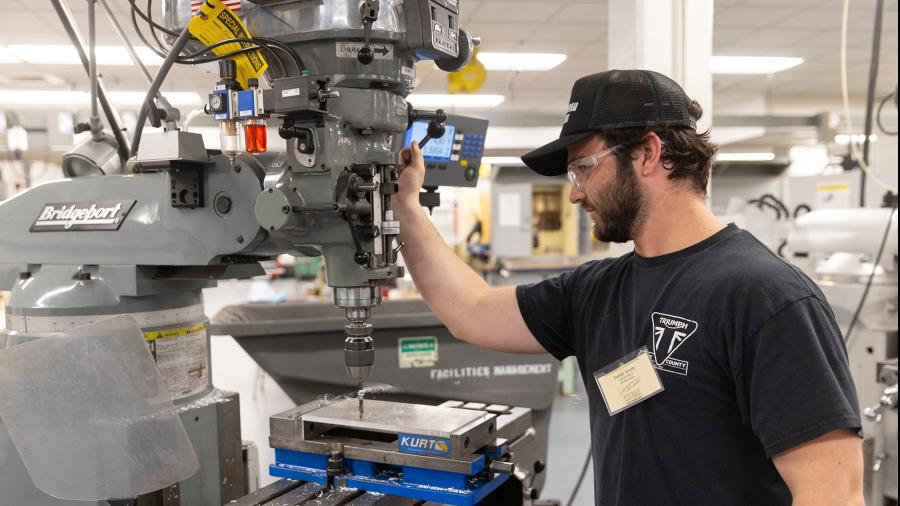Carter Smith, manufacturing engineering, machines a component for the material handling cart project.