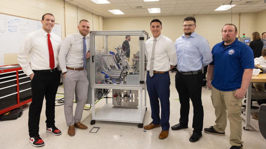 Inspiring grad Gervase Thompson with his capstone group demonstrating the NVent Hinge project