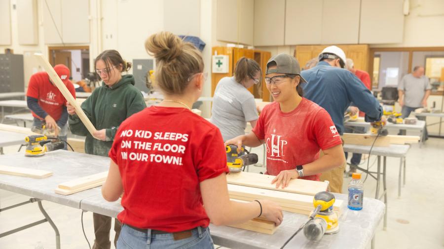 Student building wooden bed components in the Construction Lab