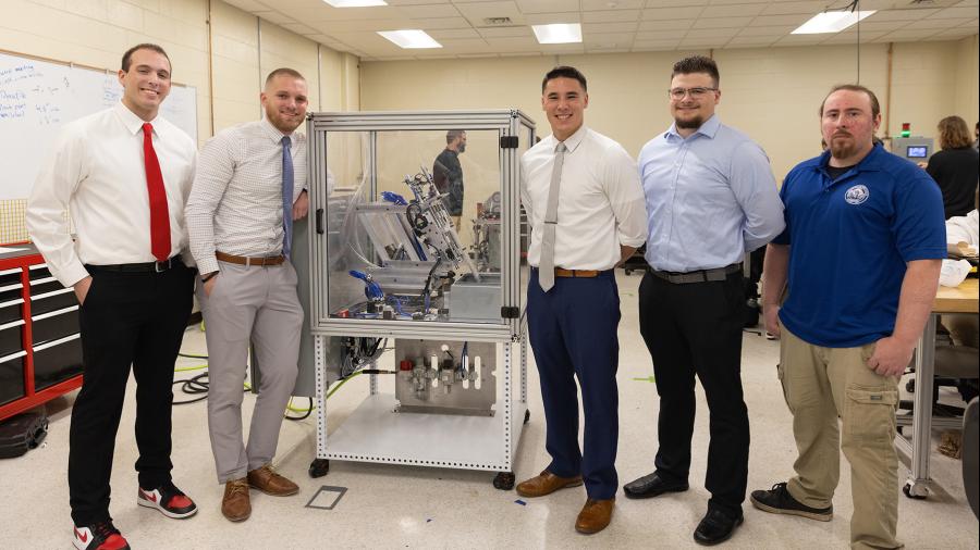 The nVent hinge demo team gathered around their design, included from left Caleb Rathje, Mack Klafter, Gervase Thompson, Evan Zaves and Andrew Hoeft.