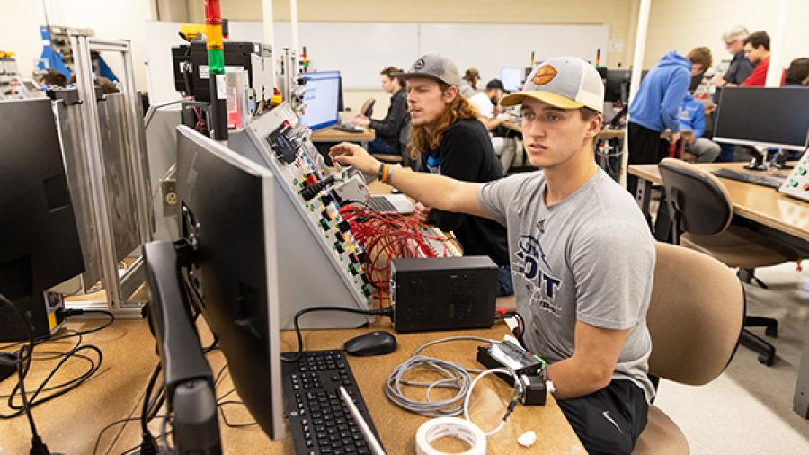 Students use controls instrumentation in engineering lab.