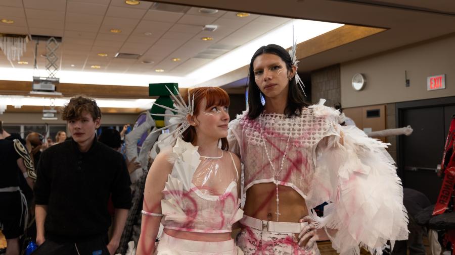 Two student group partners pose together after they walked the runway at Fashion Without Fabric.
