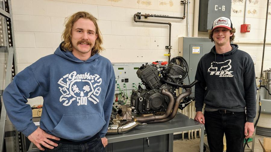 Mechanical engineering majors Charles Lenk, left, and Lucas Lirette work on the motorcycle stand in an engineering lab.