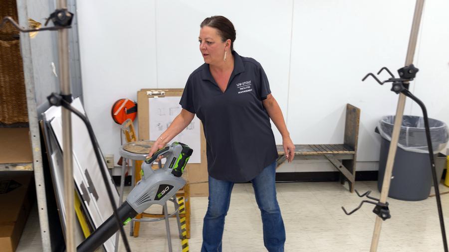 Sara Moltzan, a member of the UW-Stout academic custodial staff, uses a leaf blower while cleaning a drawing class room in the Applied Arts Building.