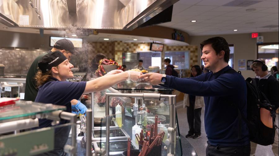 UW-Stout HRTM student Abby Bjorkstrand serves a customer at Fireside Café as part of the new lab experience in the Food Service Production and Operations.