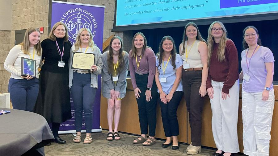 Tau Chapter members receive their national service award