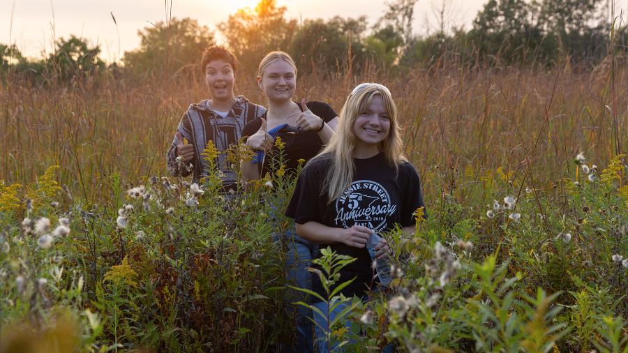 Students pose together while collecting wildlife samples for a field study.