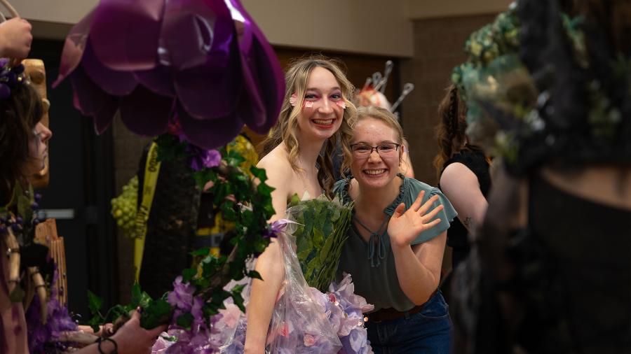 A student team behind the scenes at Fashion Without Fabric, wait their turn to walk the runway.