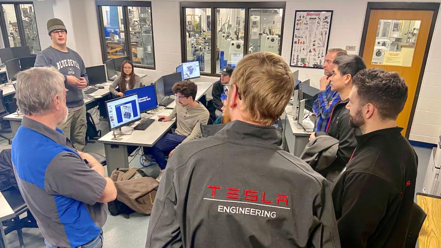 Tesla engineering employees speak with UW-Stout students in the Computer-Aided Manufacturing Lab about innovative solutions in automation.