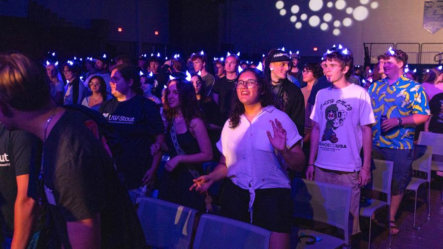 Students in a dark ballroom
