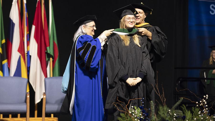 Graduate student receives hood