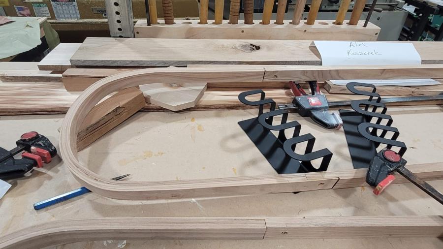 Wood and metal parts of a student-designed entryway assistant, waiting to be fitted together.